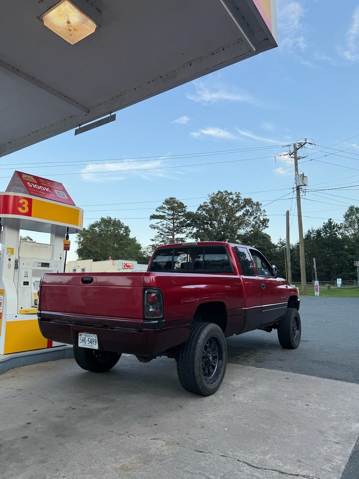 Rear three-quarter view of a restored two-tone red Dodge Ram pickup with glossy paint