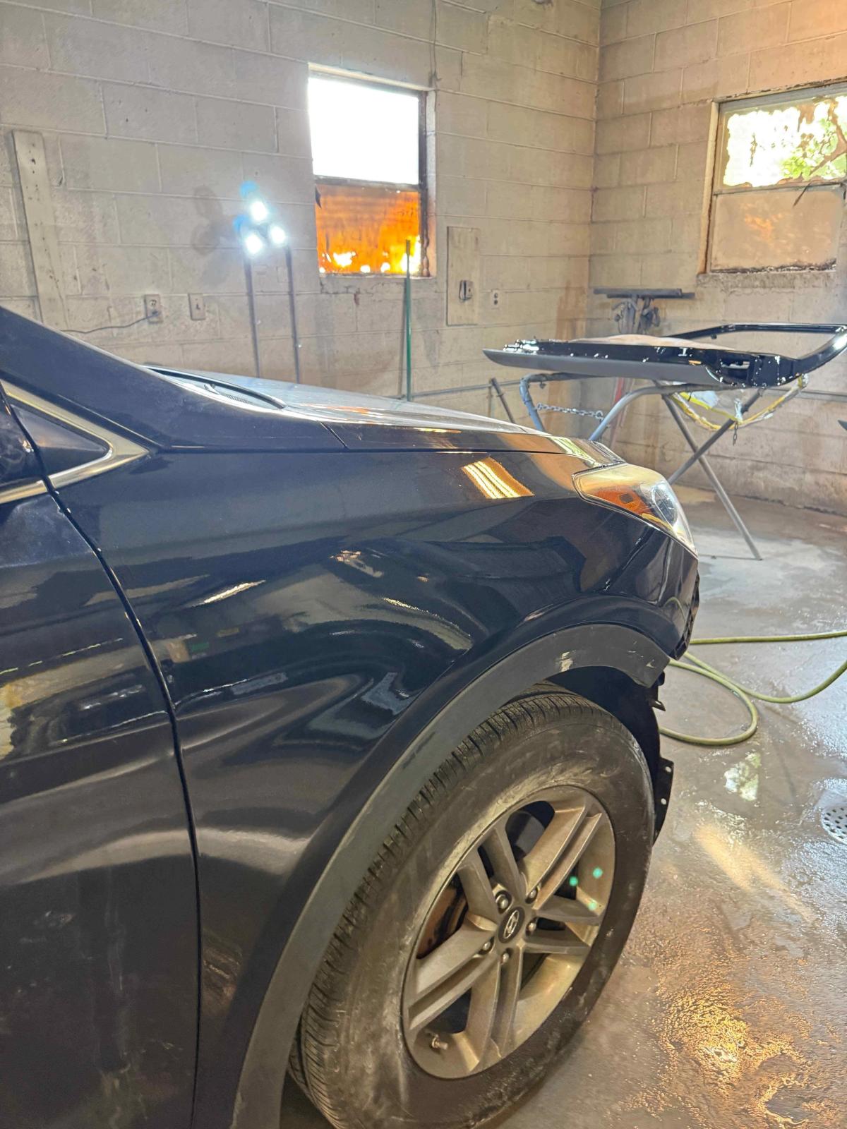 Technician performing auto body panel repair on a damaged vehicle in Gordonsville VA