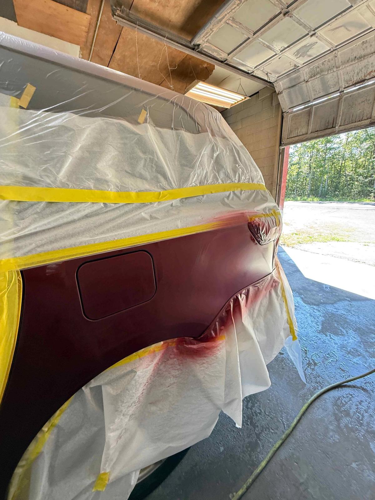 Quarter panel being repainted with color-matched base coat at In & Out Autobody