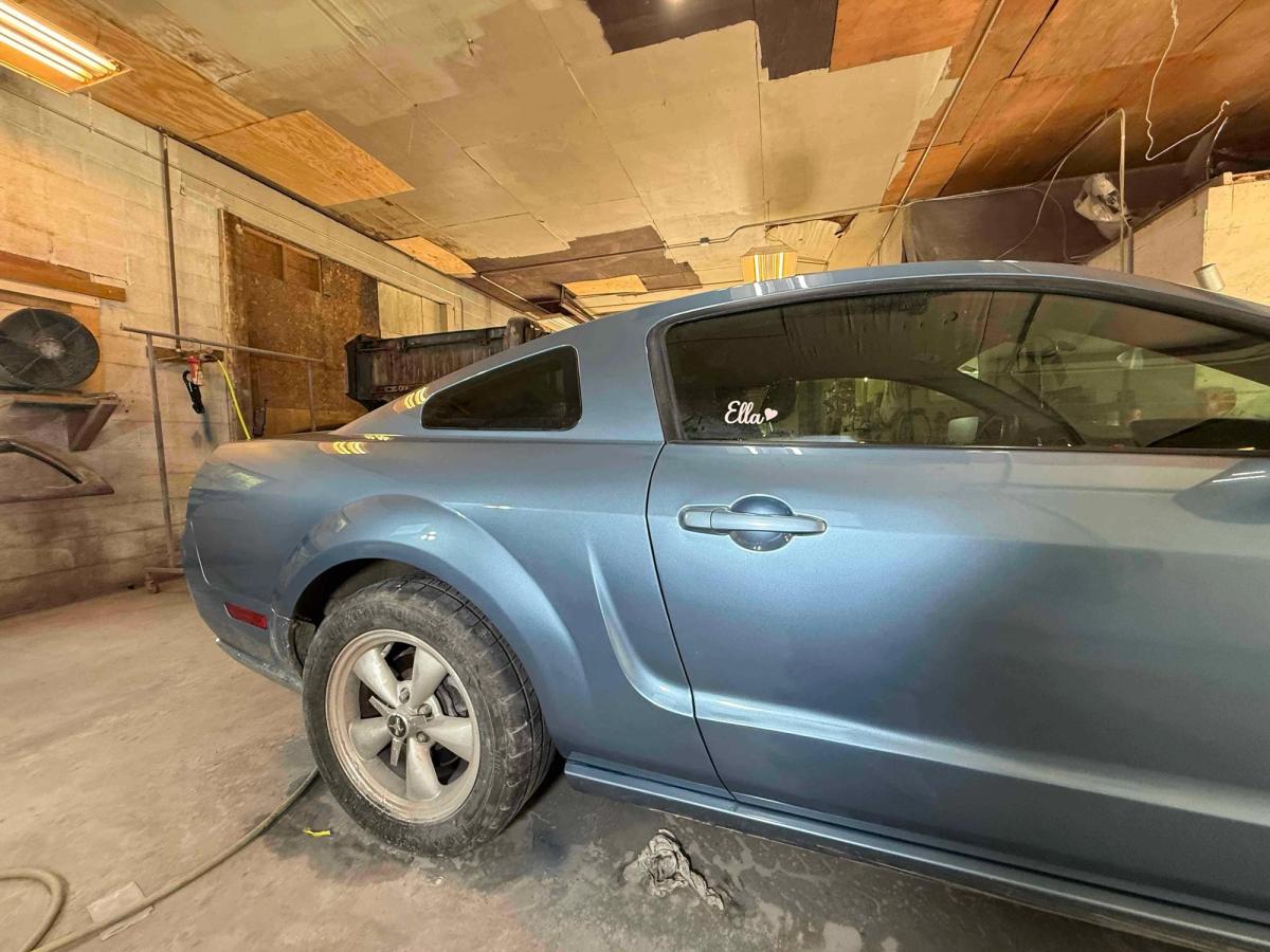 Repaired and repainted car door after dent removal with a flawless color match