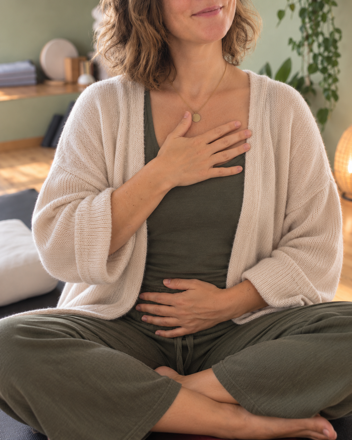 Hands resting on chest and belly - a gesture of return to the body