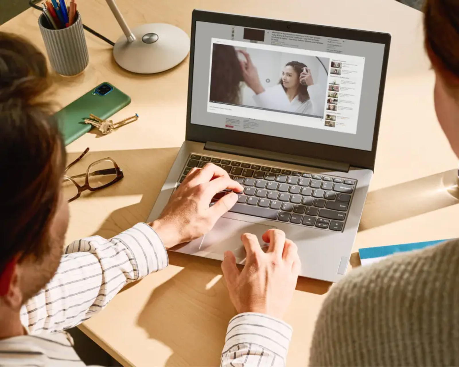 Creators using an amazon product video maker on a laptop to review listing videos.
