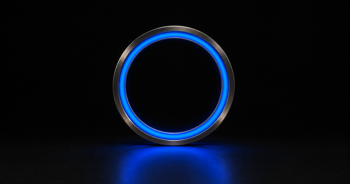 A single closed ring of dark machined metal standing upright on a black floor, its inner edge lit by one unbroken blue cobalt charge that spills onto the floor beneath it.
