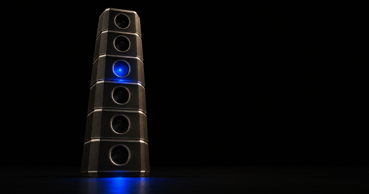 Six stacked machined dark-metal tiers rise as a single column on a black floor, seen from low and straight on, each tier holding one recessed port, with five ports dark and a single cobalt-blue charge lit at the third port from the top, spilling onto the floor below.