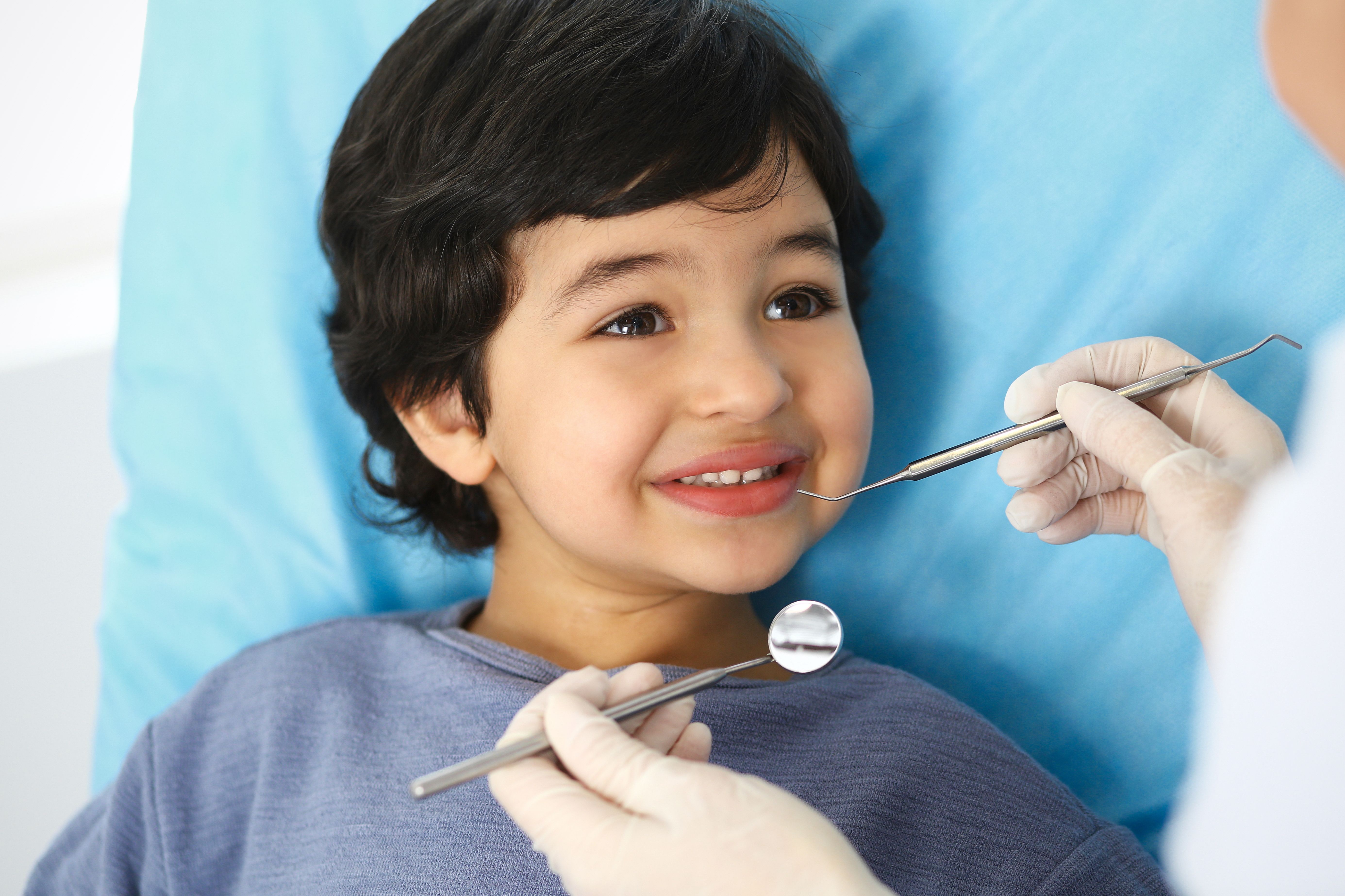Cute little boy in dentist chair - child dental surgery Kids Dental Tree Anchorage