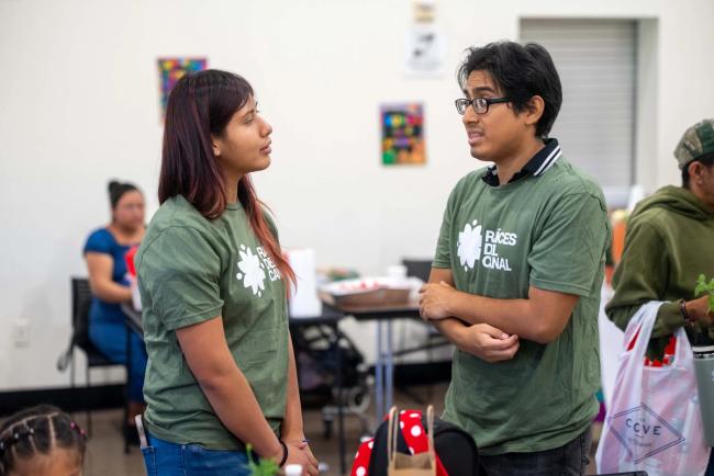 People sharing a conversation at a community event