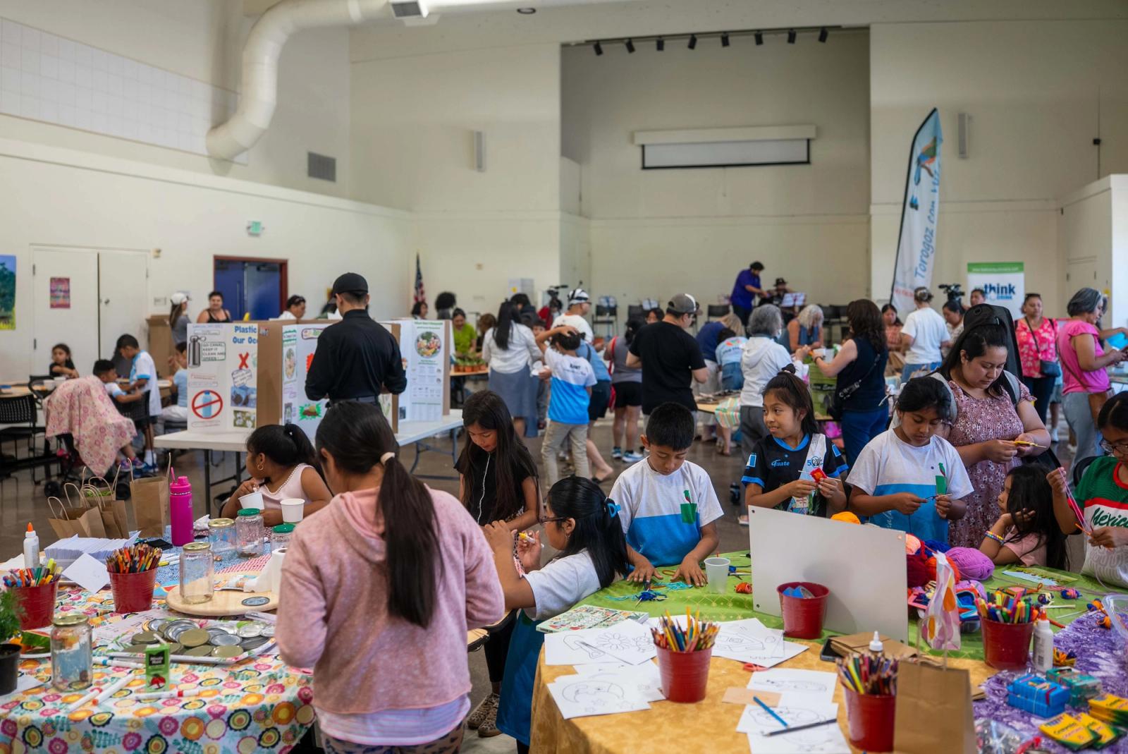 Visitors gathered around activity tables at Green Fest