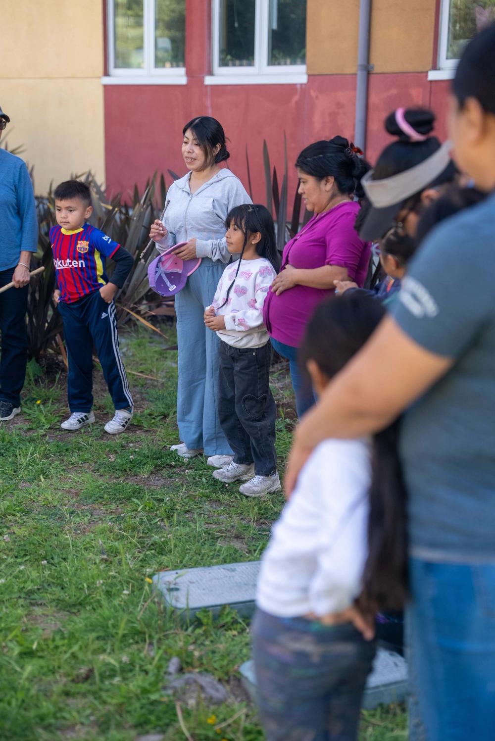 Children and adults participating in an outdoor community circle