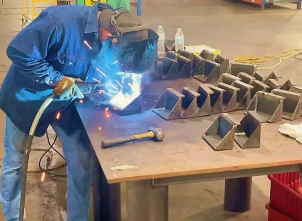 A K&H employee welding