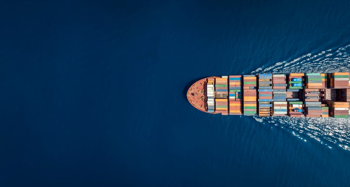 A container ship carrying freight across open ocean, seen from above