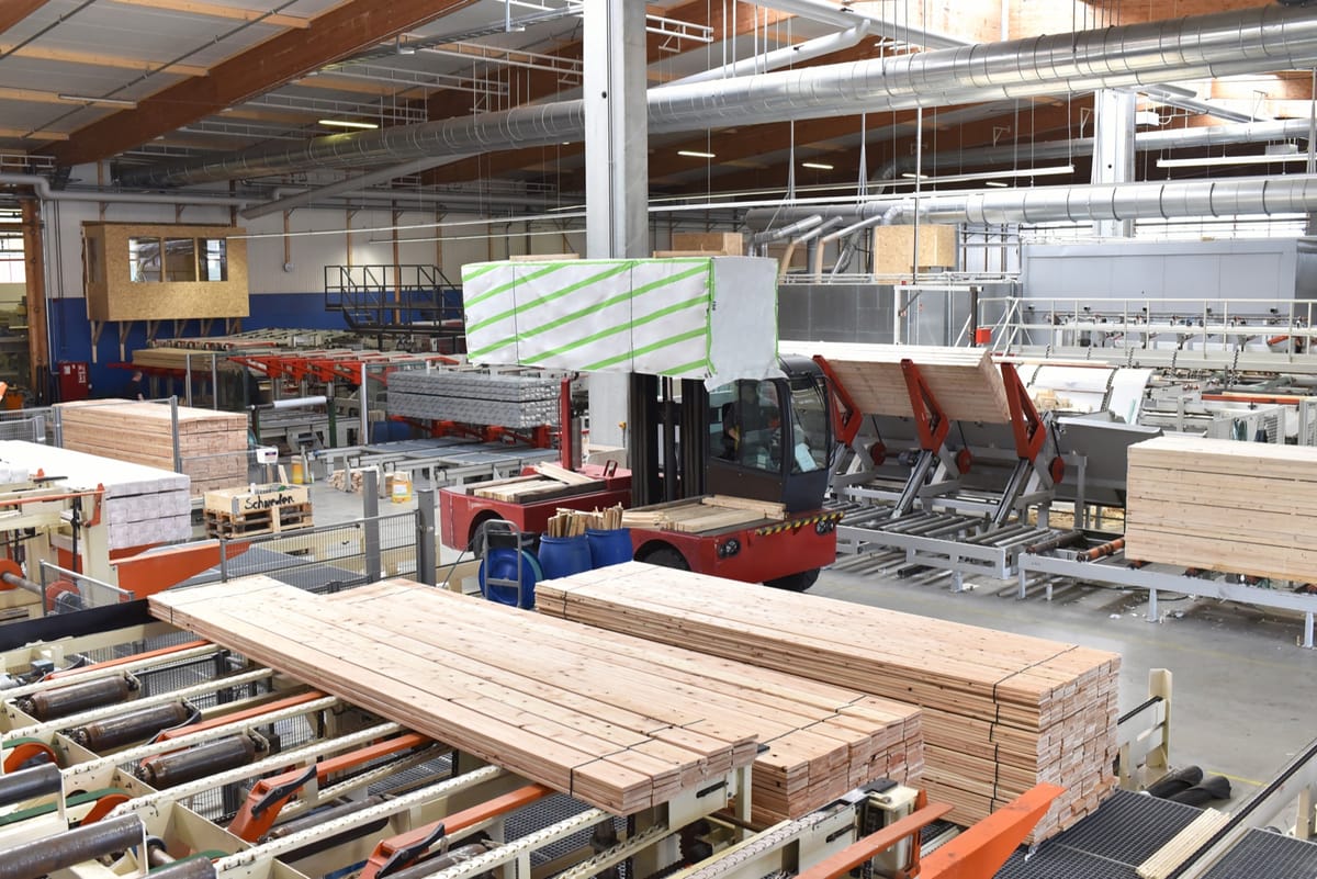 Automated production line moving finished lumber through a mill