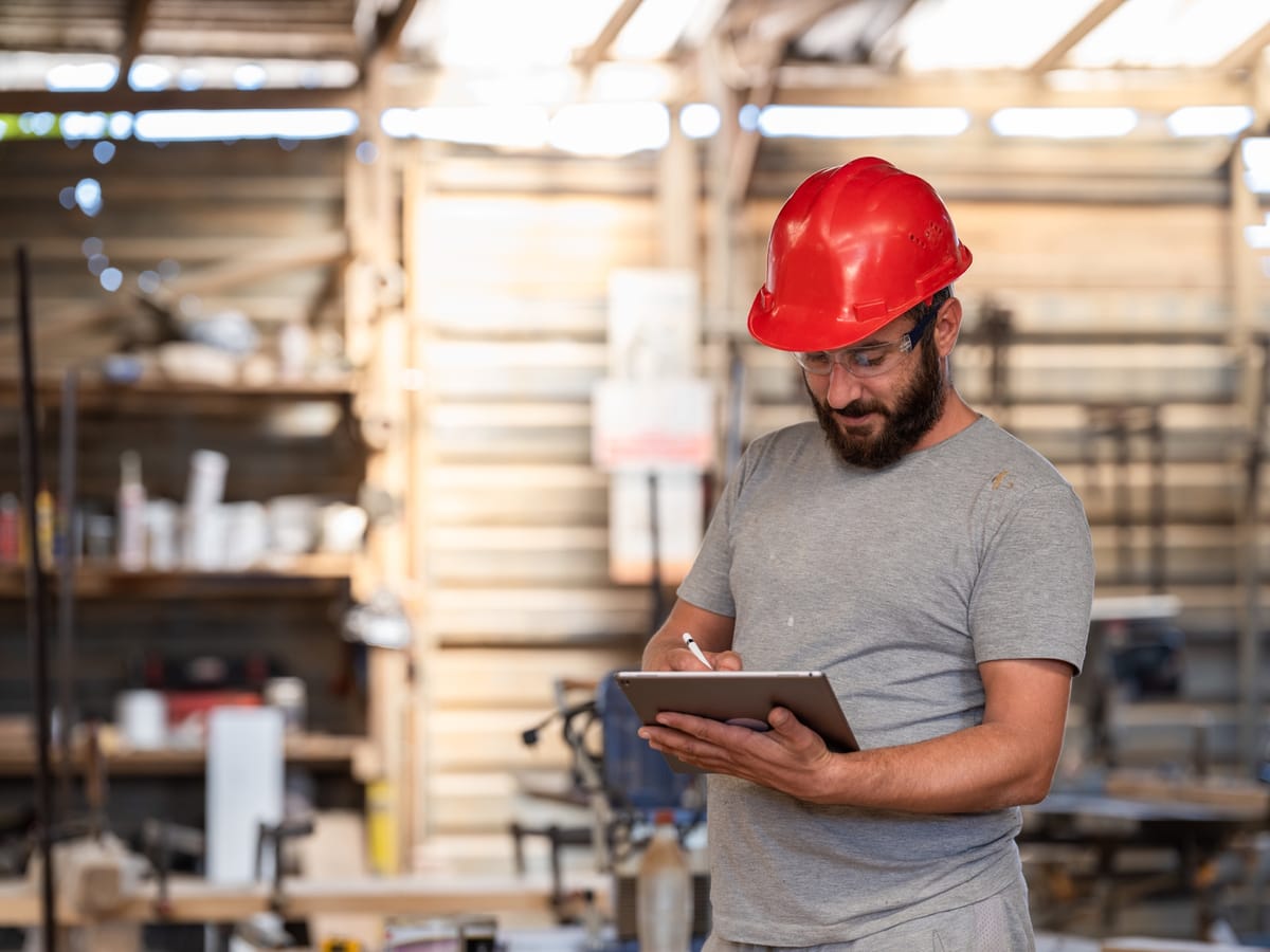 A yard supervisor confirming an order on a tablet