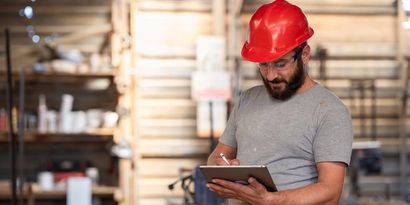 A yard supervisor confirming an order on a tablet