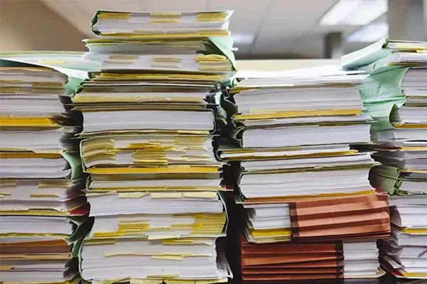 Stacks of paper files and folders