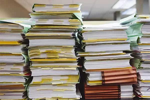 Stacks of paper files and folders