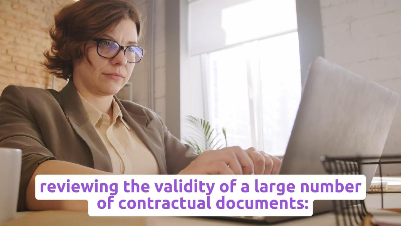 A reviewer reads a paper document beside a laptop, with source text about contract review.