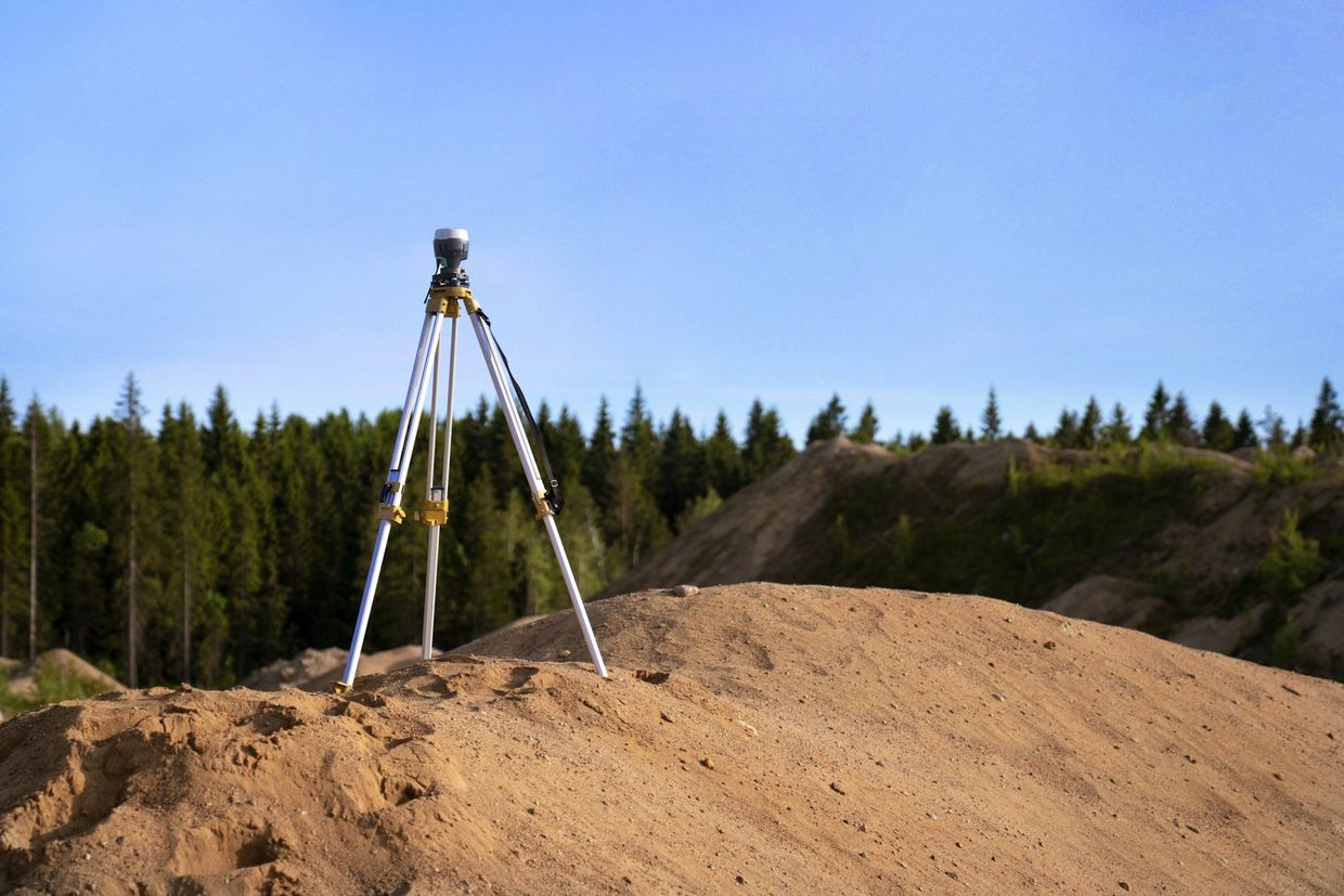 Surveyor operating a total station on a residential site