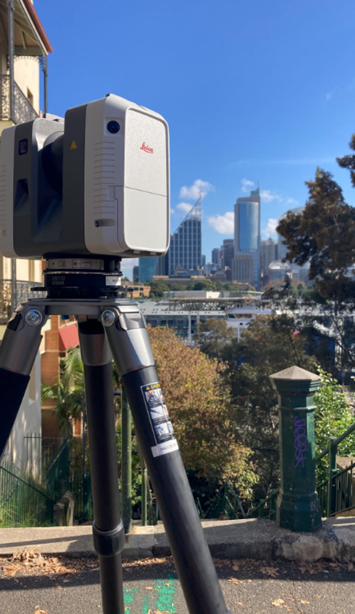 Laser scanner set up above the Sydney skyline