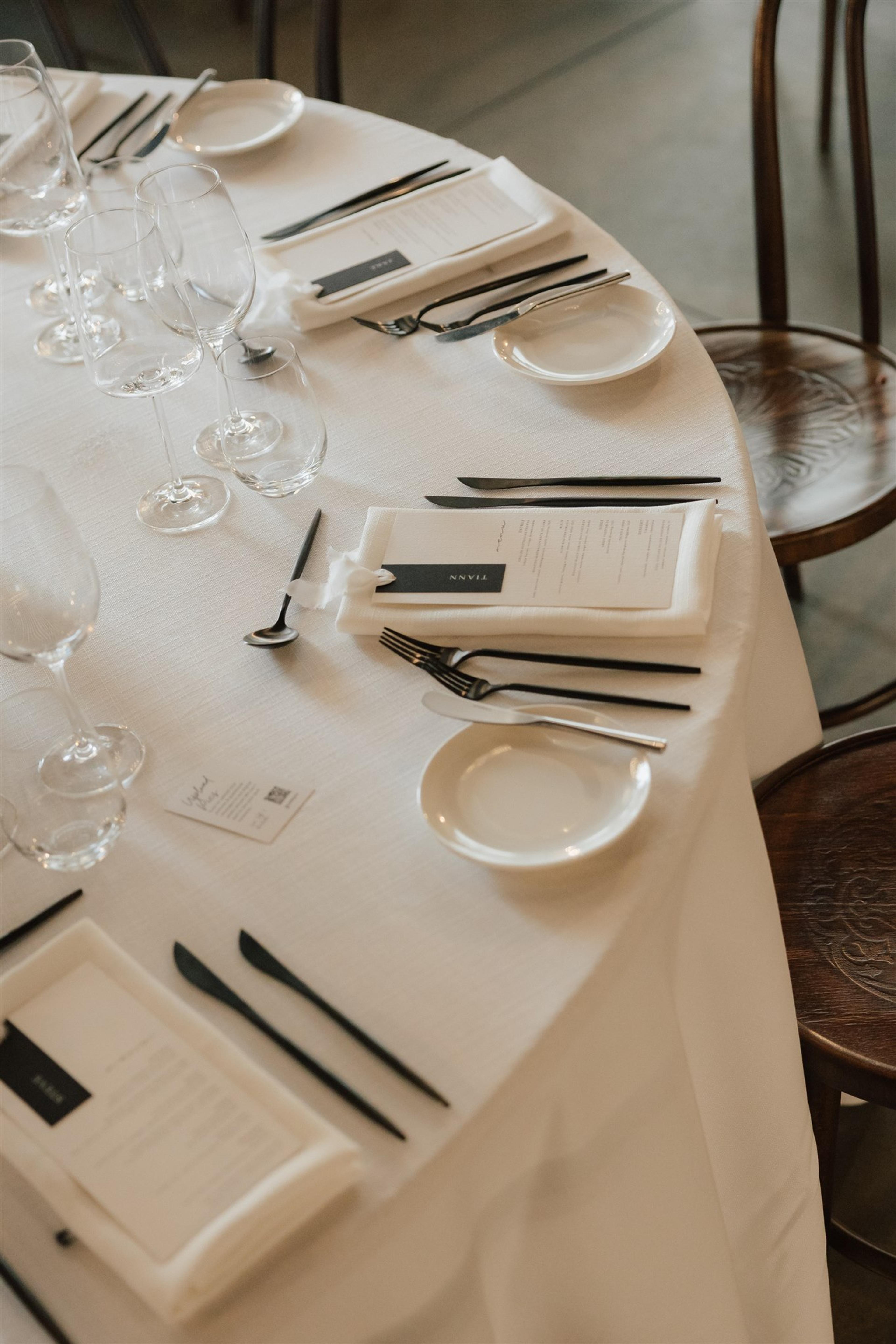 White and black wedding tablescape with menus, glassware and modern place settings at The Valley Estate Gold Coast.