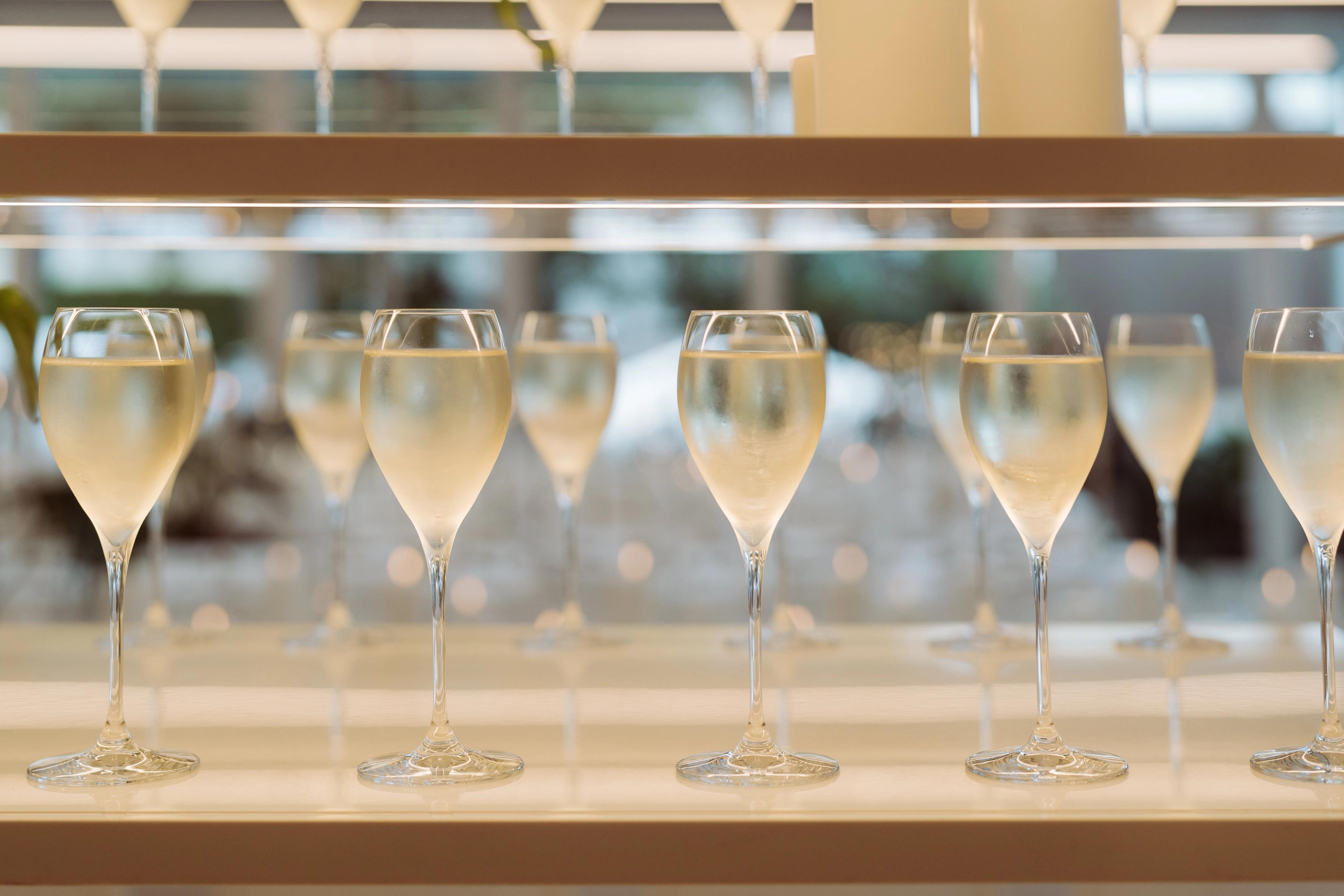 Champagne glasses lined up on the bar at Industry Beans Newstead for a Brisbane brand activation event.