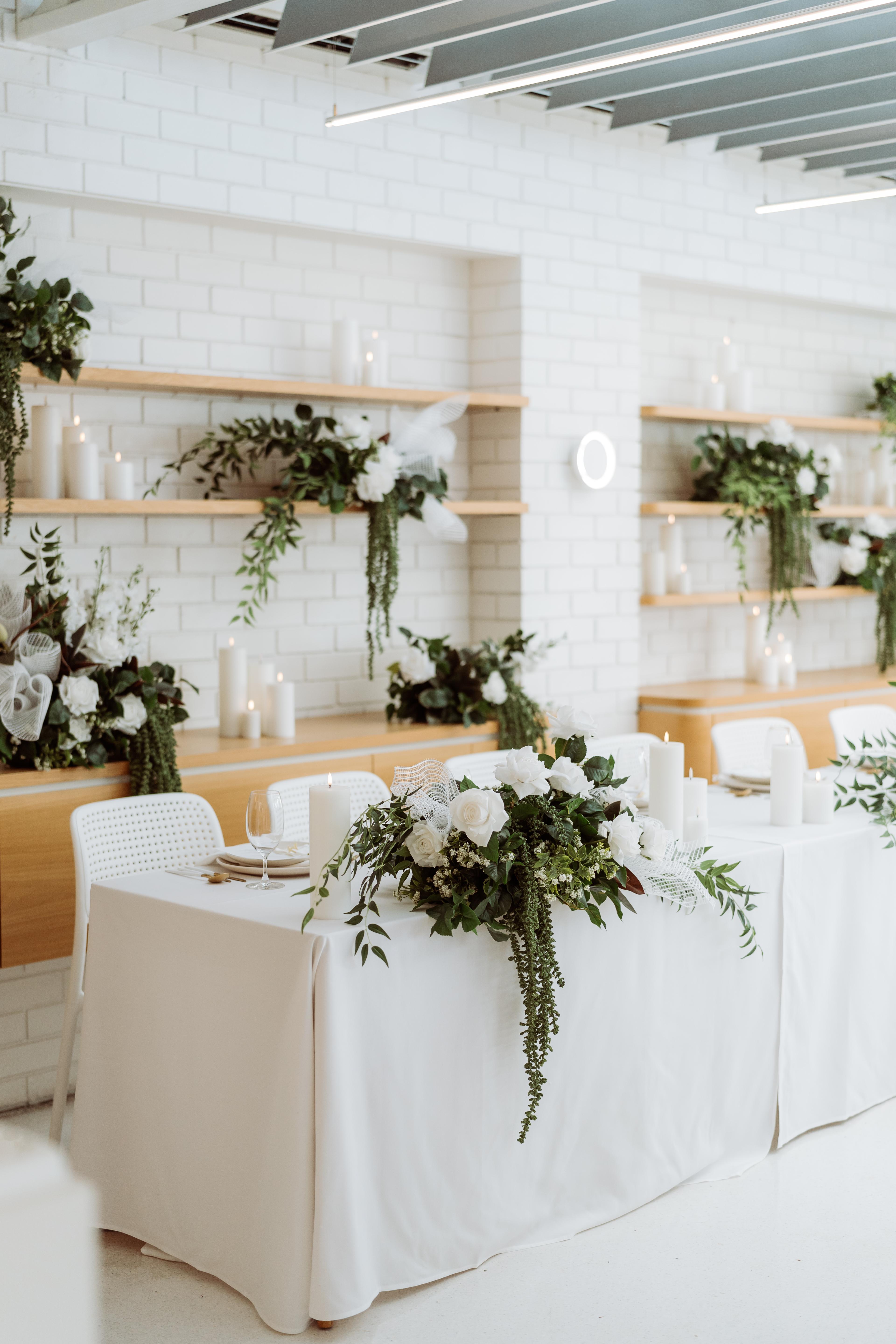 Styled event table at Industry Beans Newstead with white florals, candles and modern tablescape details for a Brisbane brand activation.