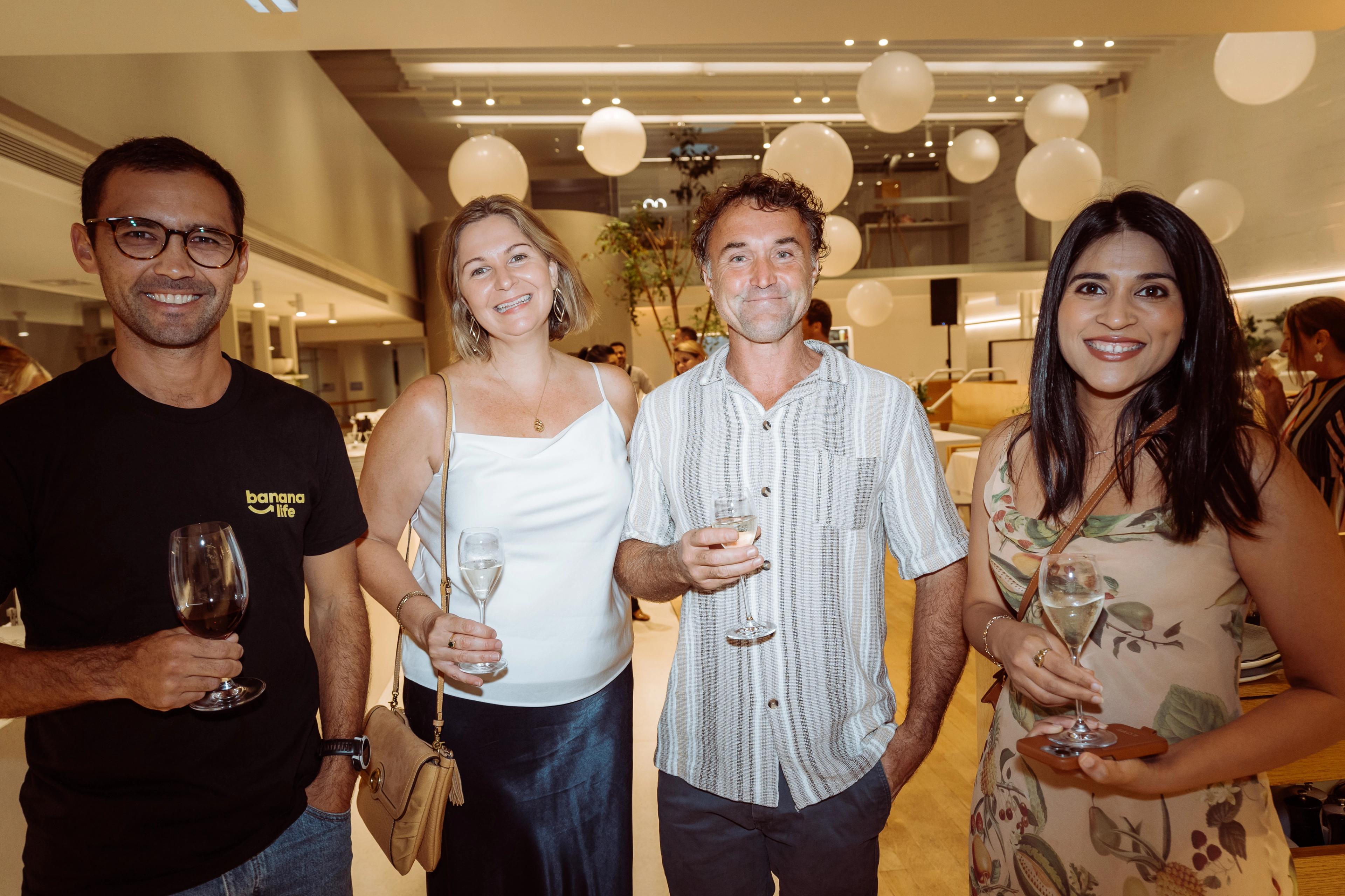Guests enjoying the Industry Beans Newstead brand activation in Brisbane, with white balloons and event styling in the background.