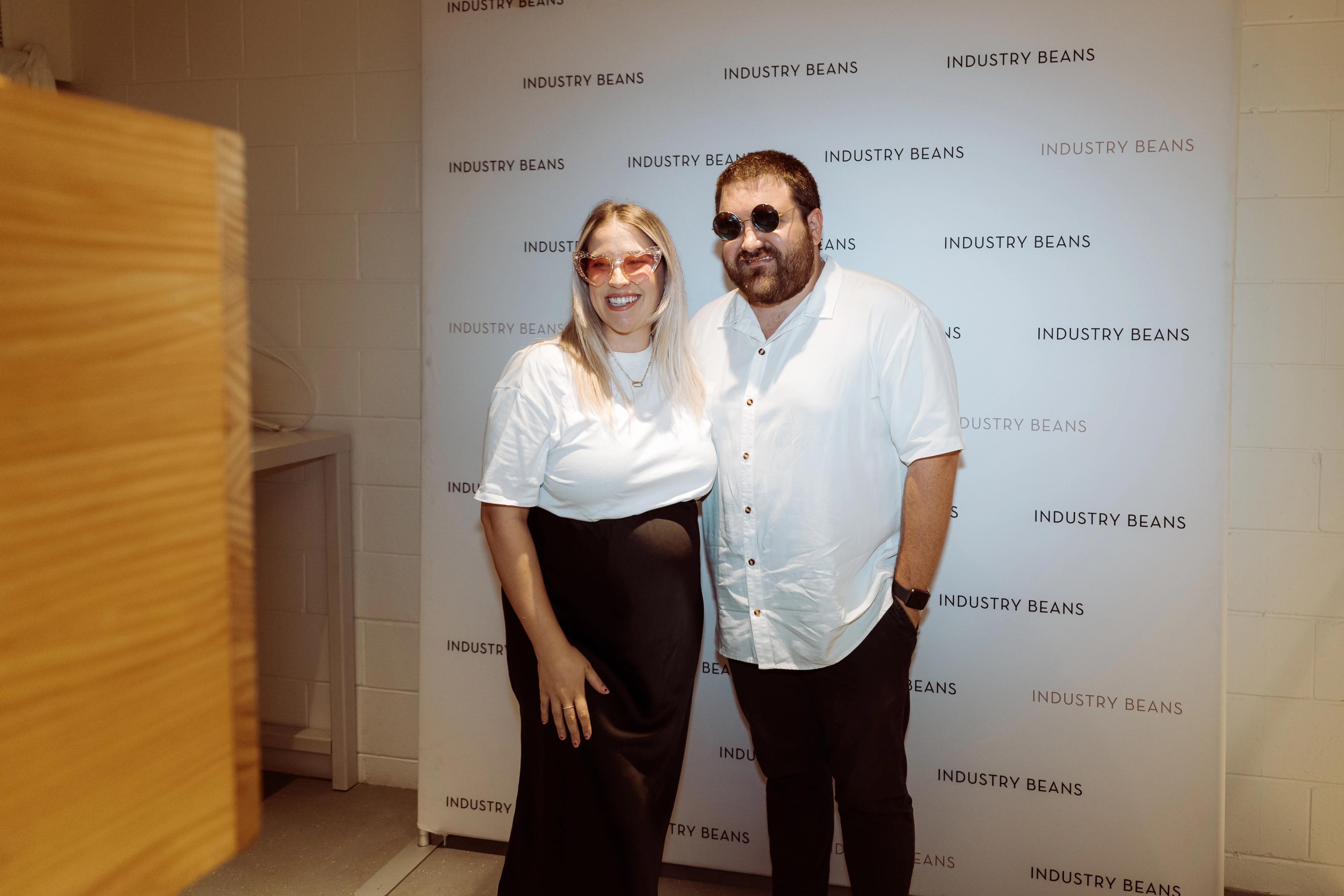 Guests posing in front of the Industry Beans media wall during the Newstead Brisbane brand activation.