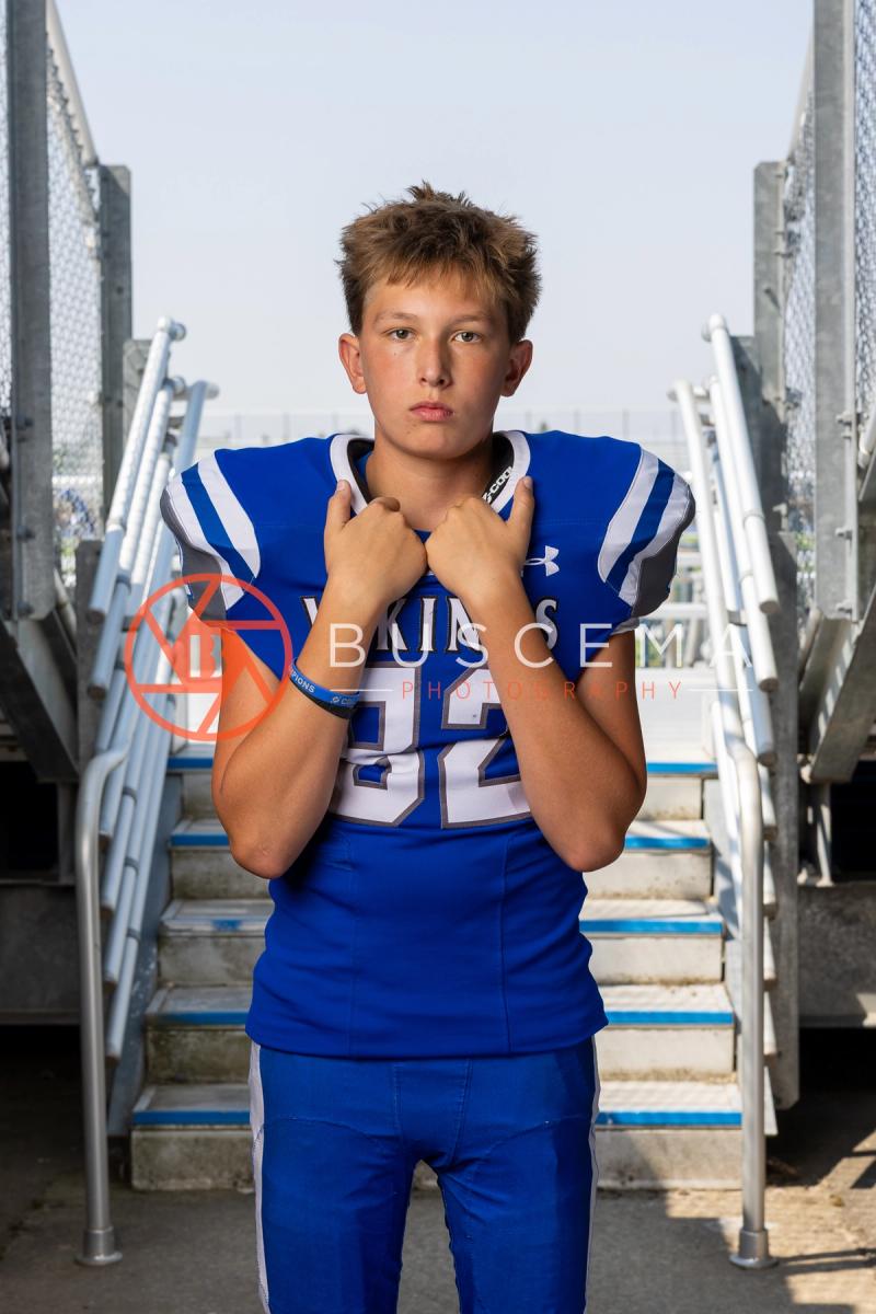 Coeur d'Alene Vikings football player portrait on the stadium bleacher steps