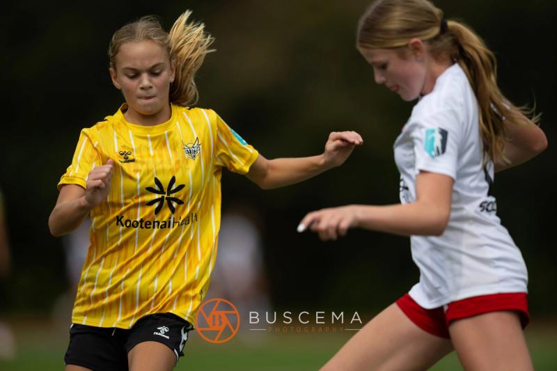 Sting 13-14G Academy player shielding the ball from a Mt. Rainier defender
