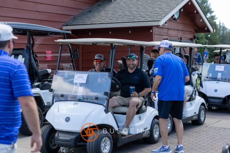 Golfers in carts getting ready to head out from the clubhouse
