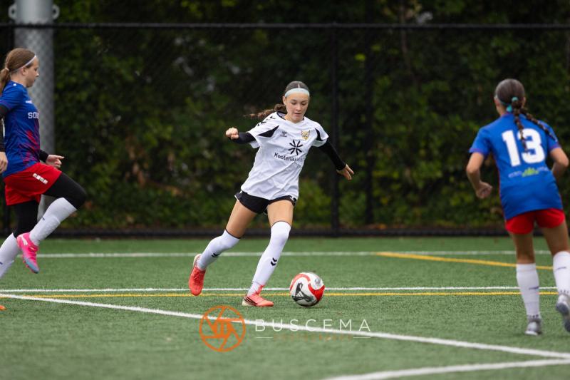 Sting 13-14G Academy player attacking with a Sound FC defender tracking back