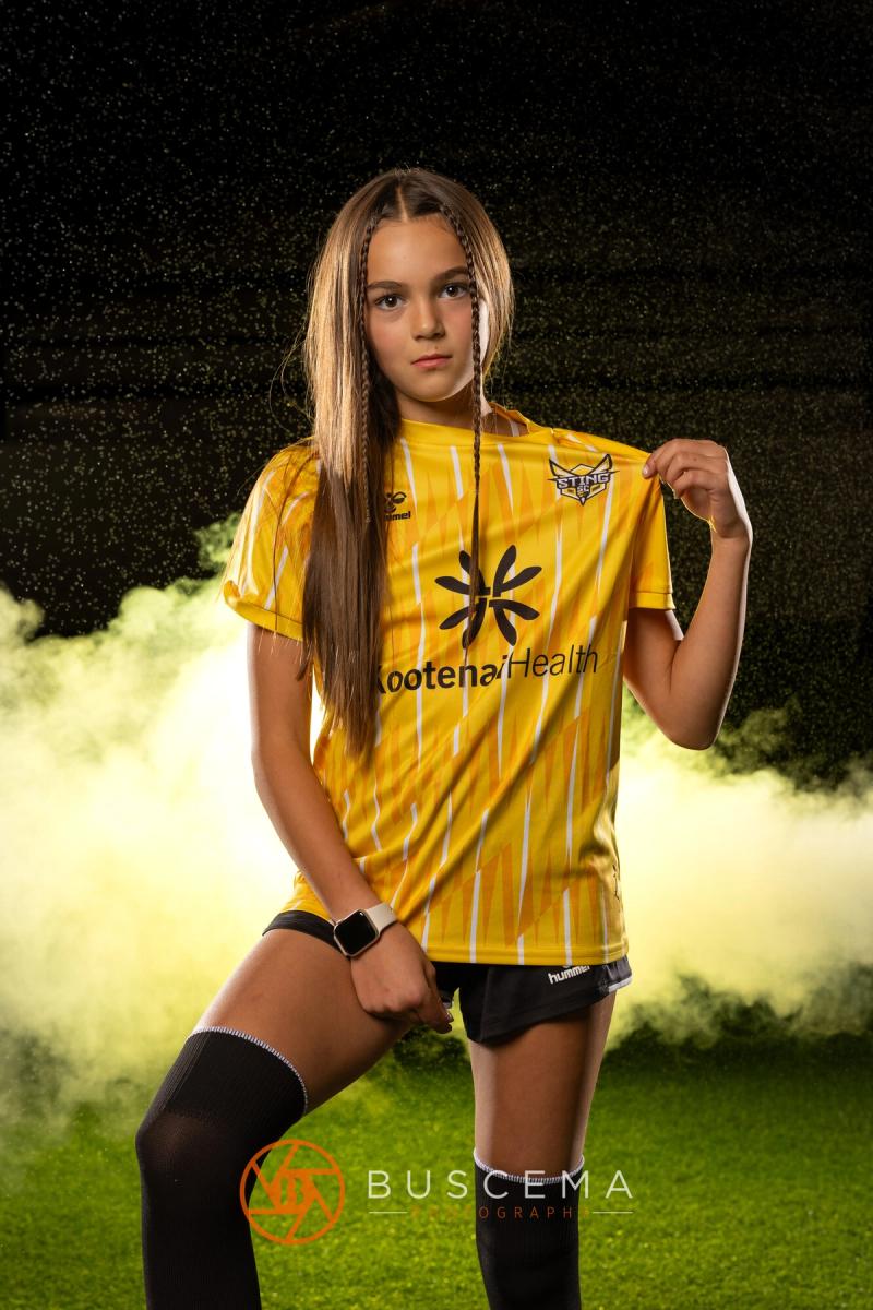 Sting 13G Academy player crouched low with her hand on her knee