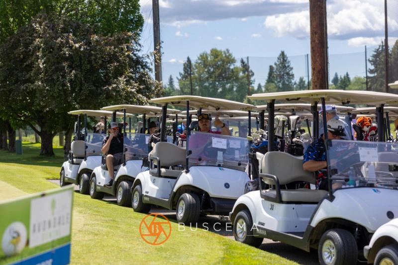 Line of golf carts waiting along the course before the shotgun start