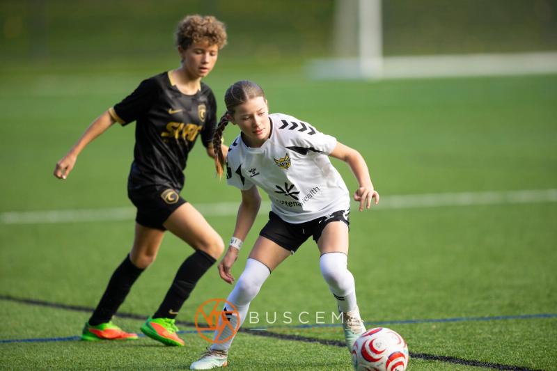Sting 13G Academy player shielding the ball from a Western WA Surf player