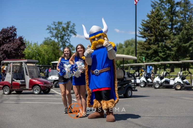CHS cheerleaders with the Coeur d'Alene Viking mascot in the cart lot at Avondale Golf Club