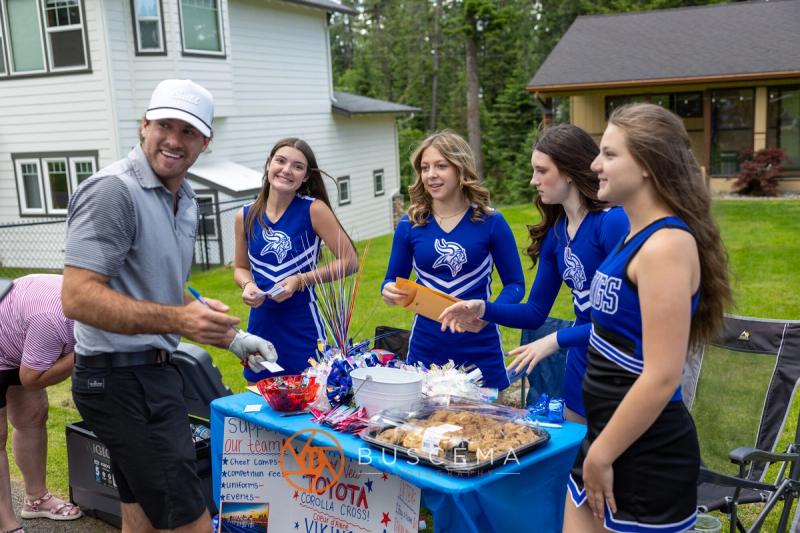 CHS cheerleaders running a fundraising table for golfers on the course