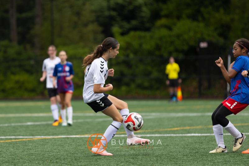Sting 13-14G Academy player with the ball at her feet against Sound FC
