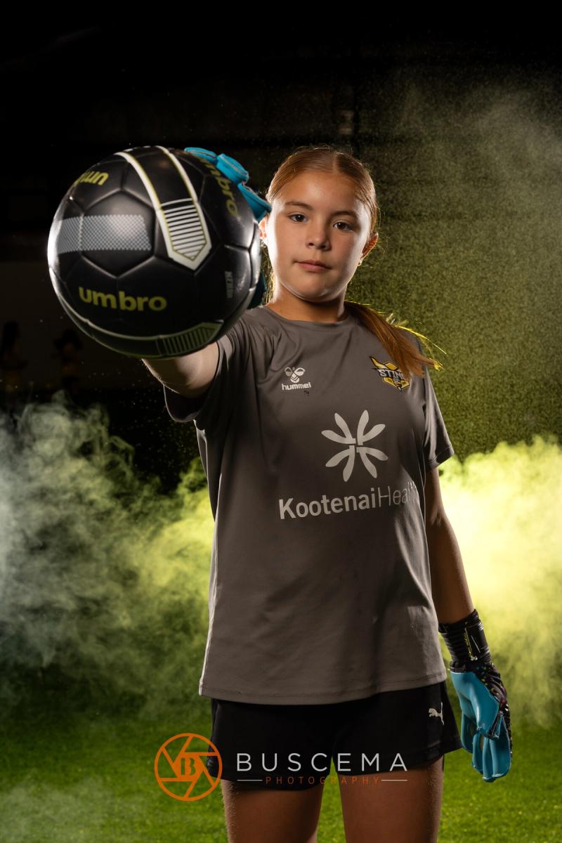 Sting 13G Academy goalkeeper holding a ball out toward the camera