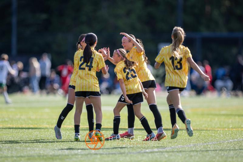 Sting 13G Academy teammates hugging after a goal