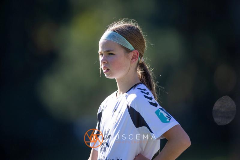 Close up of a Sting 13G Academy player in a headband watching the play