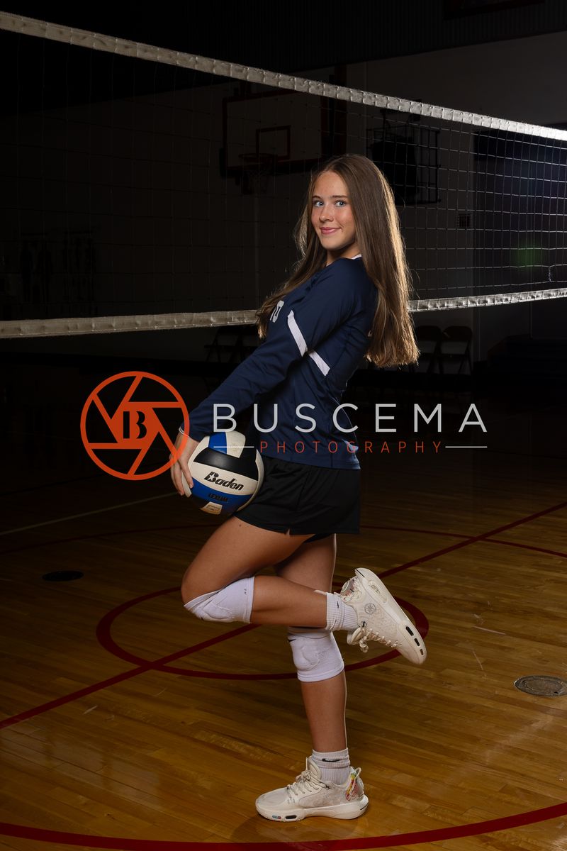 Coeur du Christ Academy Saints volleyball player posed at the net