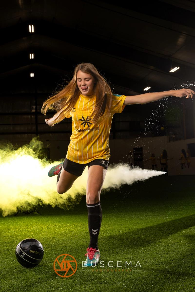 Sting 13G Academy player kicking a ball through the smoke
