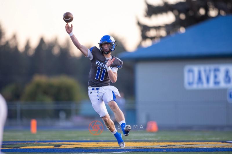 Coeur d'Alene quarterback number 11 releasing a pass against Lewis and Clark