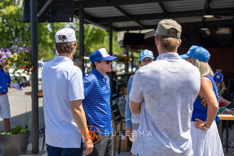Golfers in blue gathering and talking before the shotgun start