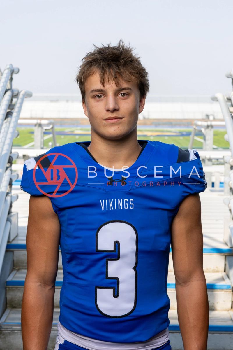 CHS Vikings football player in a number 3 jersey on the stadium bleacher steps