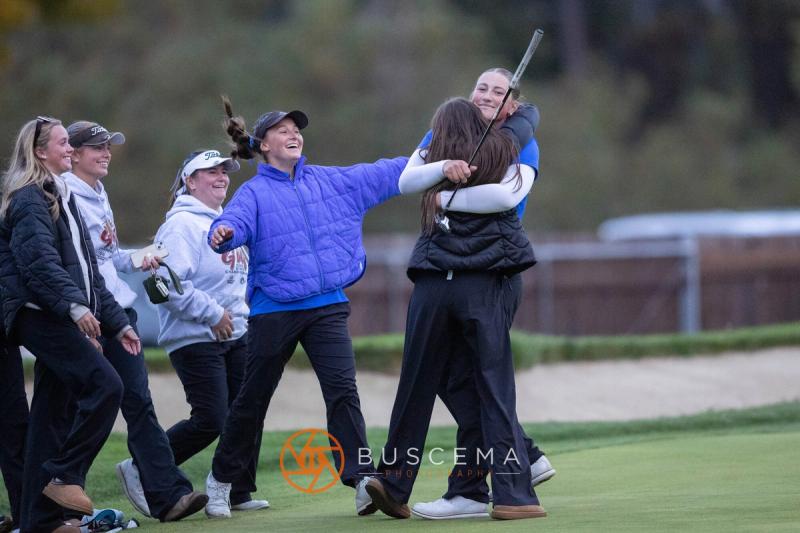 Coeur d'Alene girls golfers celebrating together on the green at the 6A state golf championships at Avondale Golf Club