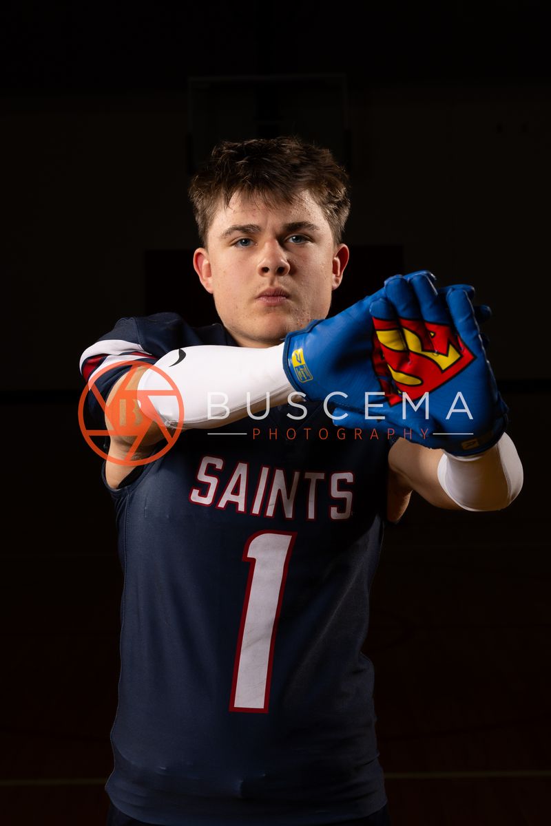 Coeur du Christ Academy Saints football player in a number 1 jersey holding a football