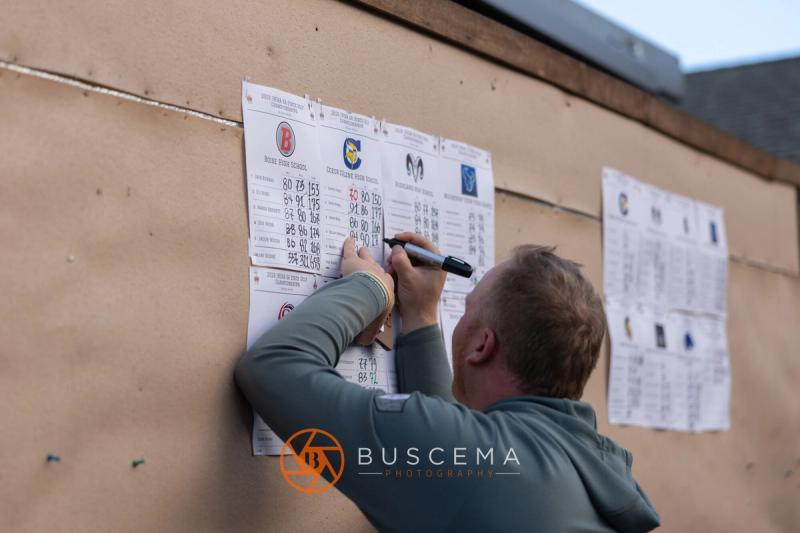 Scores being posted on the board by the clubhouse at the 6A state golf championships at Avondale Golf Club