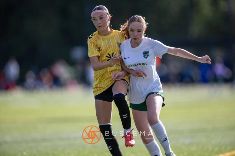 Sting 13G Academy player and a Harbor Premier player going shoulder to shoulder