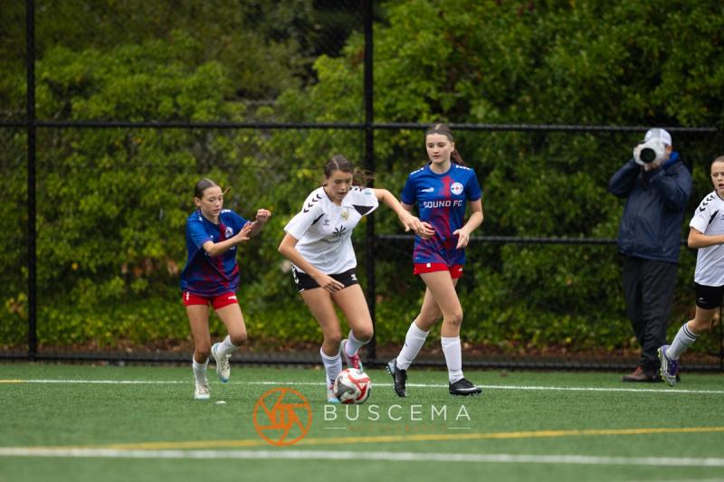 Sting 13-14G Academy and Sound FC players contesting the ball in midfield